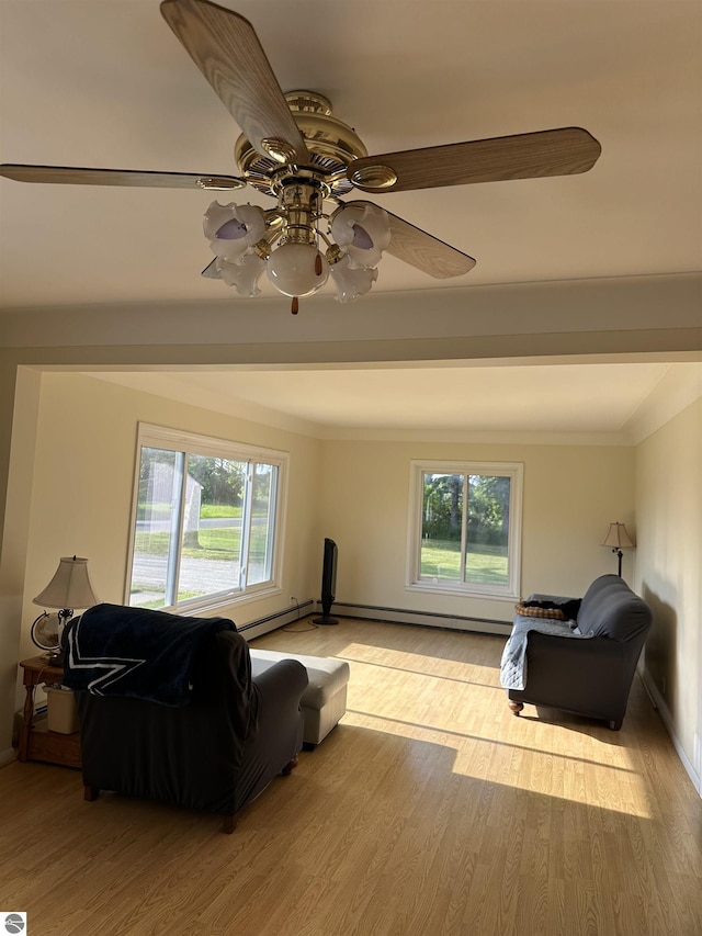 1339 S Melita Rd, Sterling, MI 48659 - living area with healthy amount of natural light, light wood-style flooring, ceiling fan, a baseboard radiator, and crown molding