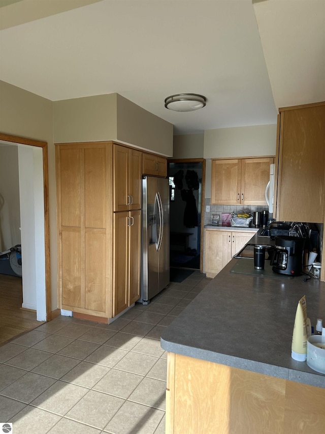 1339 S Melita Rd, Sterling, MI 48659 - kitchen with stainless steel fridge with ice dispenser, light tile patterned floors, decorative backsplash, and white microwave
