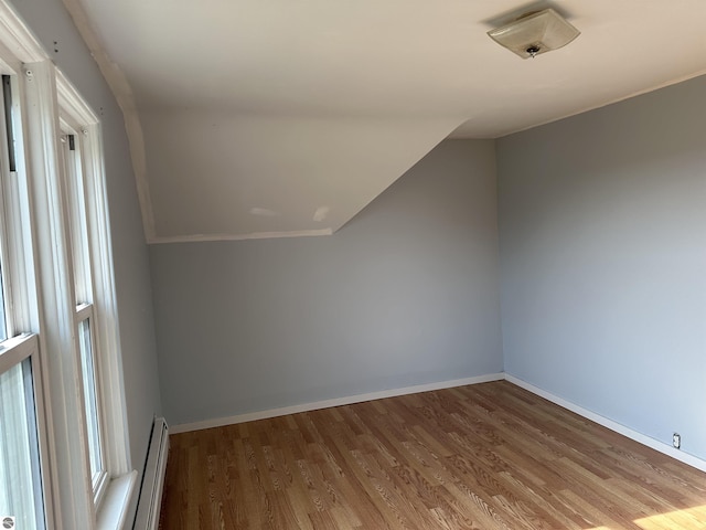 1339 S Melita Rd, Sterling, MI 48659 - bonus room featuring wood finished floors, a baseboard heating unit, and lofted ceiling
