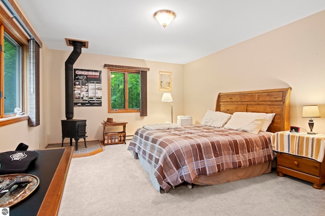 9420 E Traverse Hwy, Traverse City, MI 49684 - carpeted bedroom with a wood stove