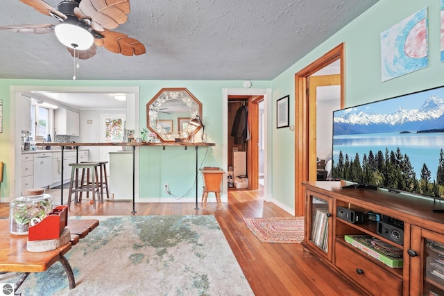 821 Indian Trail Blvd, Traverse City, MI 49686 - living area featuring light wood-style flooring, ceiling fan, and a textured ceiling