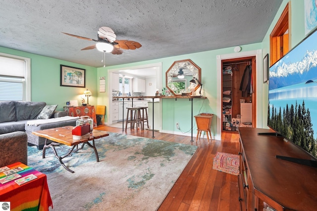 821 Indian Trail Blvd, Traverse City, MI 49686 - living area featuring a ceiling fan, hardwood / wood-style floors, and a textured ceiling