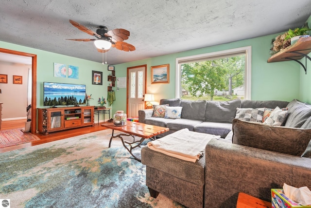 821 Indian Trail Blvd, Traverse City, MI 49686 - living room with wood finished floors, ceiling fan, and a textured ceiling