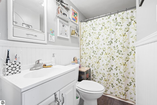 821 Indian Trail Blvd, Traverse City, MI 49686 - full bathroom featuring vanity, wood finished floors, a wainscoted wall, and a shower with curtain