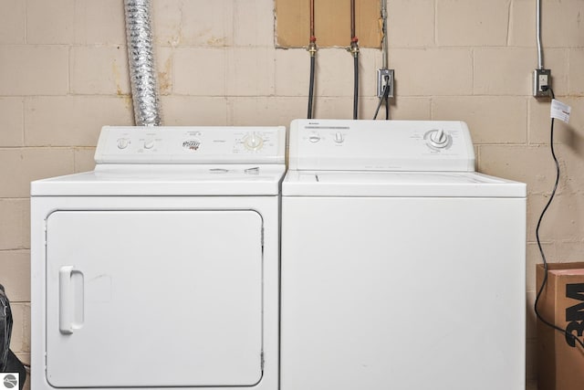 821 Indian Trail Blvd, Traverse City, MI 49686 - laundry area with concrete block wall and washer and clothes dryer
