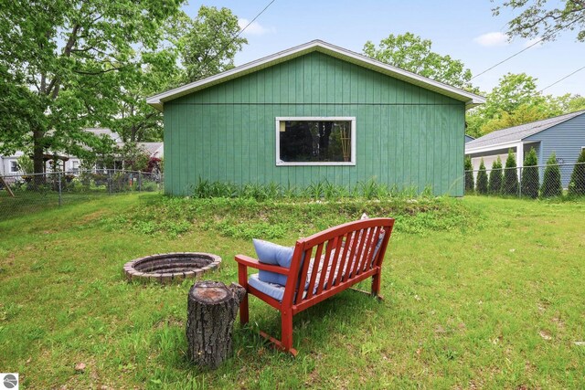 821 Indian Trail Blvd, Traverse City, MI 49686 - view of side of home featuring an outdoor fire pit