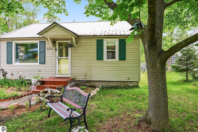 821 Indian Trail Blvd, Traverse City, MI 49686 - bungalow-style house with a front yard and a metal roof