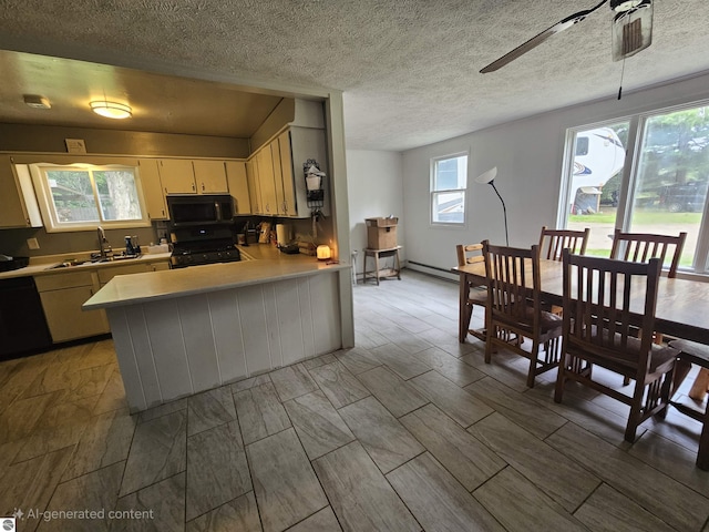 622 W Houghton Lake Rd, Lake City, MI 49651 - kitchen featuring black appliances, light countertops, a ceiling fan, a peninsula, and a textured ceiling