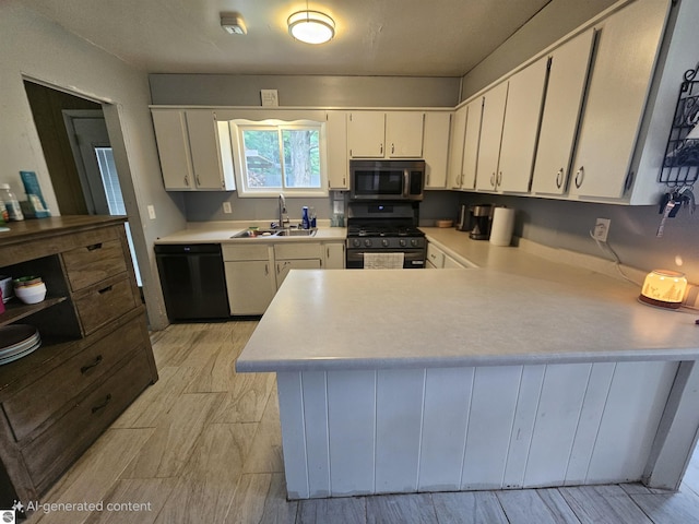 622 W Houghton Lake Rd, Lake City, MI 49651 - kitchen with black appliances, light countertops, a peninsula, and white cabinetry