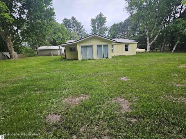 622 W Houghton Lake Rd, Lake City, MI 49651 - rear view of house with a lawn