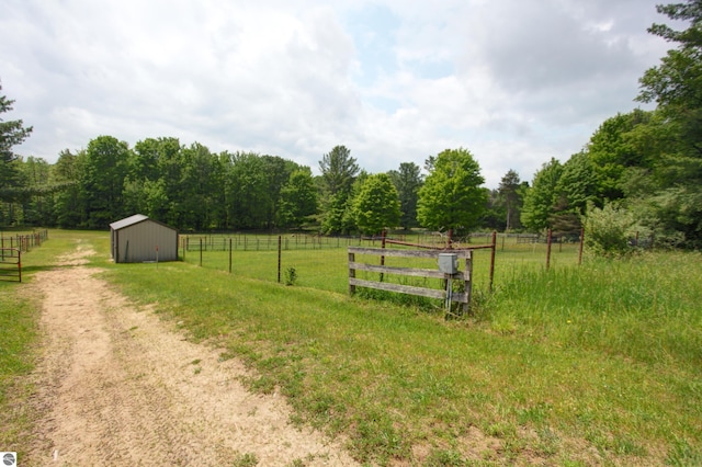 8124 Crisp Rd, Williamsburg, MI 49690 - view of yard with a rural view, an outdoor structure, and a forest view