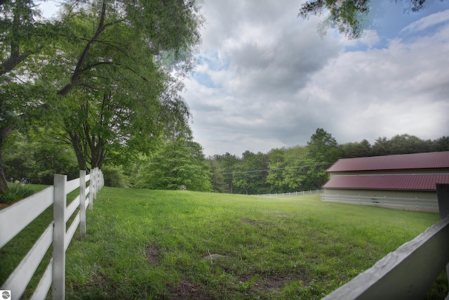 8124 Crisp Rd, Williamsburg, MI 49690 - view of yard featuring a wooded view