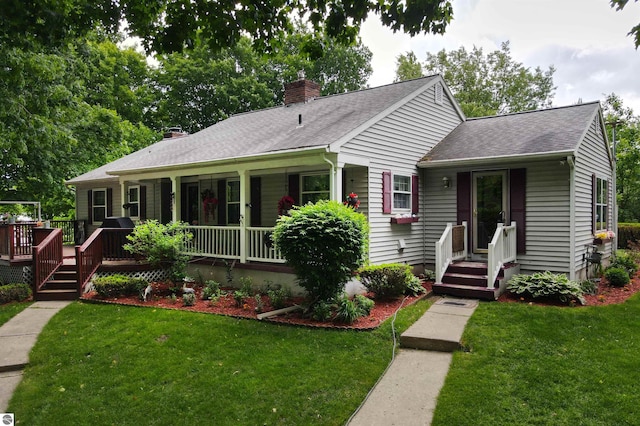 8124 Crisp Rd, Williamsburg, MI 49690 - single story home featuring a chimney, a front lawn, roof with shingles, and a wooden deck
