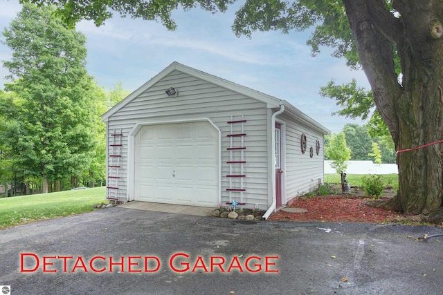 8124 Crisp Rd, Williamsburg, MI 49690 - detached garage featuring driveway