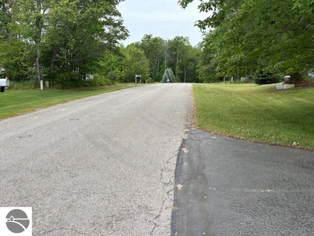 2615 Antelope Trl, West Branch, MI 48661 - view of asphalt road featuring a view of trees
