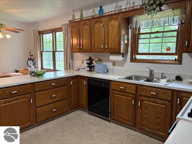 2615 Antelope Trl, West Branch, MI 48661 - kitchen with dishwasher, brown cabinets, light countertops, a peninsula, and a ceiling fan
