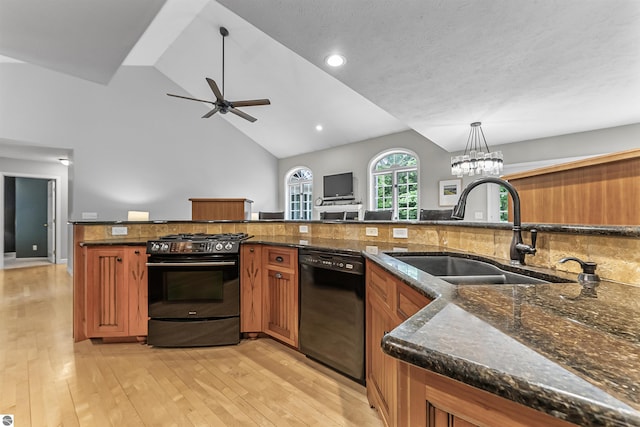 4180 Pintail Dr, Traverse City, MI 49696 - kitchen with stainless steel range with gas stovetop, black dishwasher, brown cabinetry, ceiling fan, and light wood-type flooring