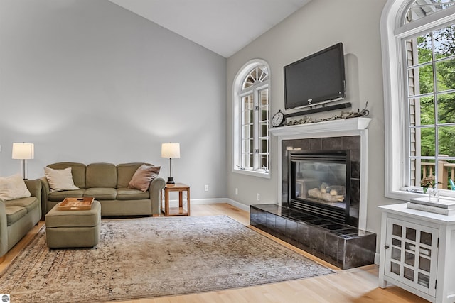 4180 Pintail Dr, Traverse City, MI 49696 - living room with wood finished floors, lofted ceiling, and a tile fireplace