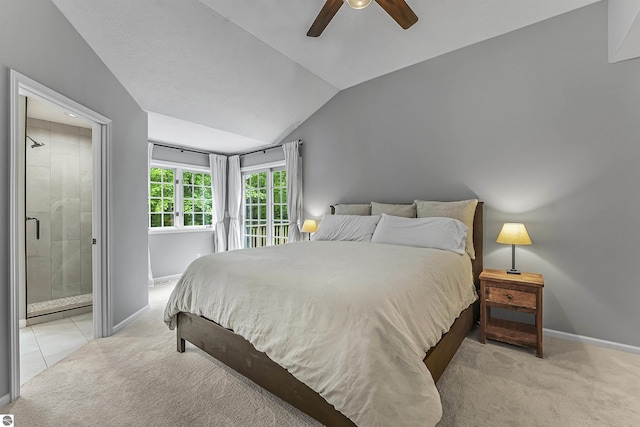 4180 Pintail Dr, Traverse City, MI 49696 - bedroom featuring light colored carpet, vaulted ceiling, ensuite bath, and ceiling fan