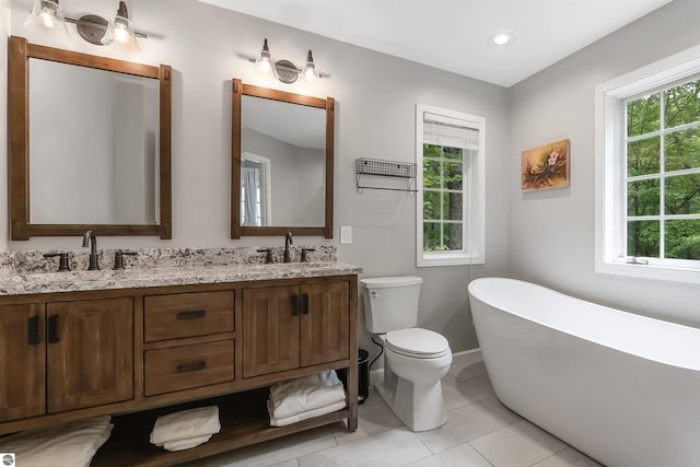 4180 Pintail Dr, Traverse City, MI 49696 - bathroom with a freestanding tub, double vanity, plenty of natural light, tile patterned flooring, and recessed lighting