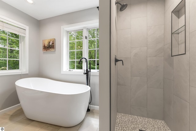4180 Pintail Dr, Traverse City, MI 49696 - bathroom with healthy amount of natural light, a freestanding bath, a tile shower, and recessed lighting