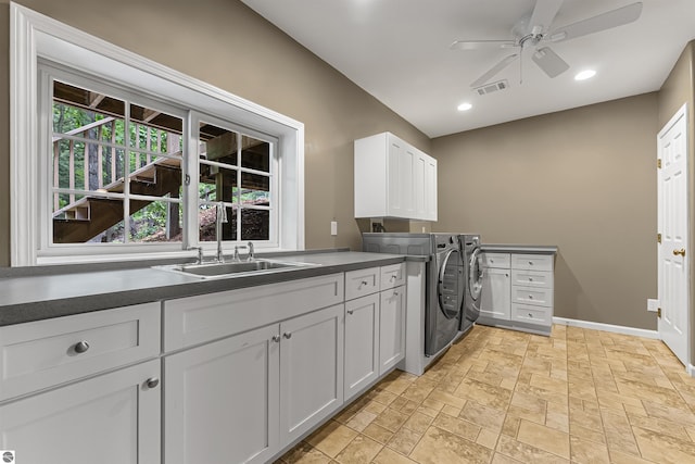 4180 Pintail Dr, Traverse City, MI 49696 - laundry room with cabinet space, separate washer and dryer, a ceiling fan, stone tile flooring, and recessed lighting