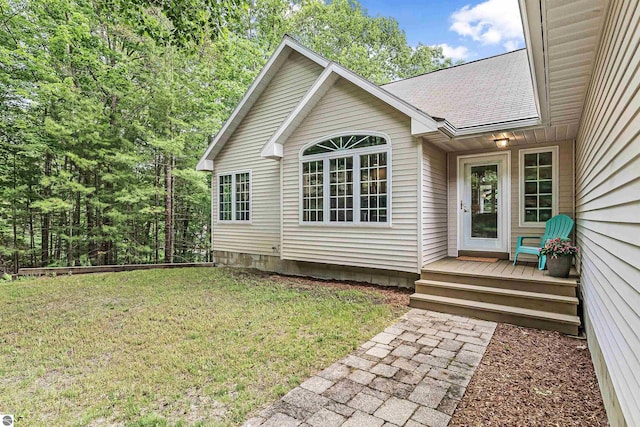 4180 Pintail Dr, Traverse City, MI 49696 - view of exterior entry featuring a lawn