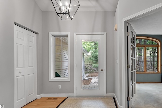 4180 Pintail Dr, Traverse City, MI 49696 - foyer featuring a chandelier and light wood-type flooring