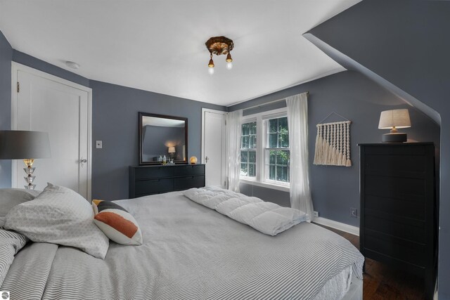 701 Sixth St, Traverse City, MI 49684 - bedroom featuring wood finished floors and vaulted ceiling