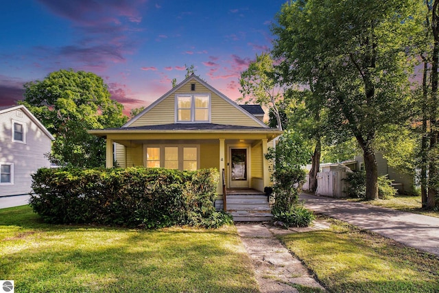 311 E Bennett Ave, Mount Pleasant, MI 48858 - bungalow featuring covered porch and a yard