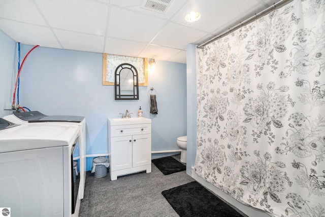 311 E Bennett Ave, Mount Pleasant, MI 48858 - bathroom featuring washing machine and clothes dryer, a paneled ceiling, vanity, and curtained shower