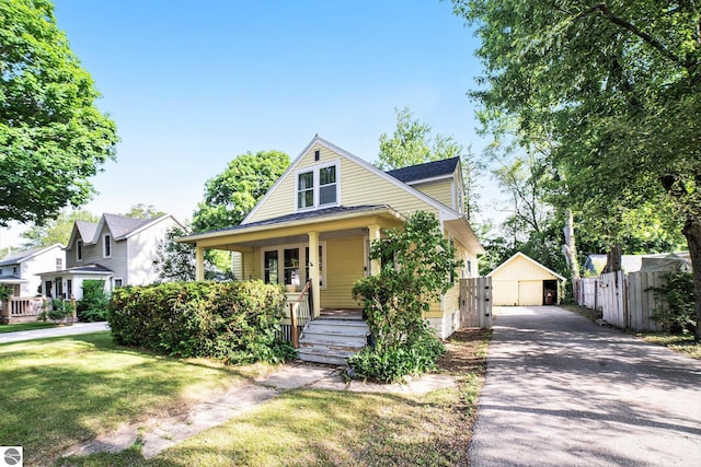 311 E Bennett Ave, Mount Pleasant, MI 48858 - bungalow-style house featuring a porch, a gate, and a detached garage