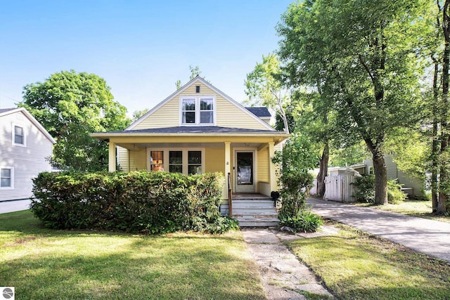 311 E Bennett Ave, Mount Pleasant, MI 48858 - bungalow-style home featuring covered porch, a front yard, and driveway