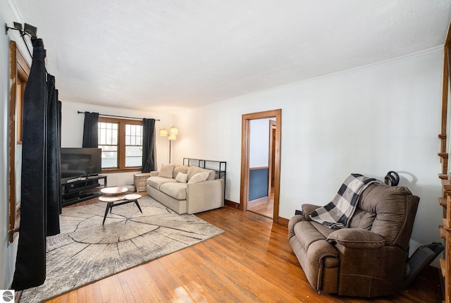 311 E Bennett Ave, Mount Pleasant, MI 48858 - living room with hardwood / wood-style flooring, a barn door, and ornamental molding