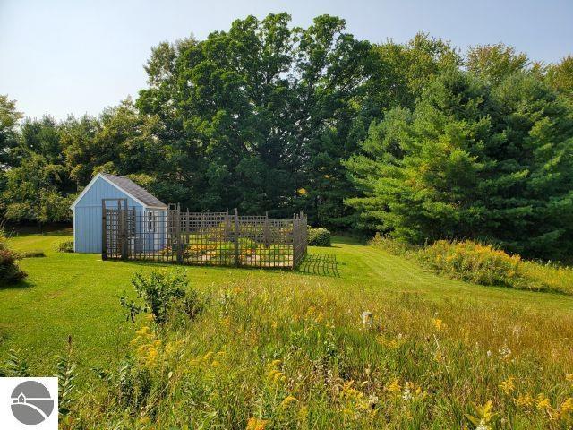 5736 Greenwood Rd, Gladwin, MI 48624 - view of green lawn with a storage shed