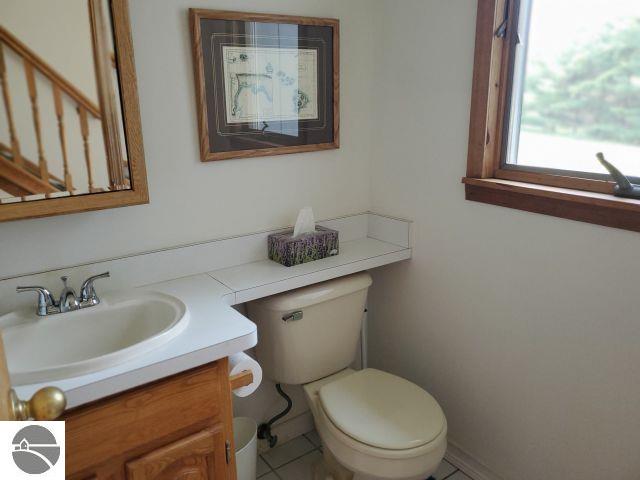 5736 Greenwood Rd, Gladwin, MI 48624 - half bathroom featuring vanity and tile patterned floors