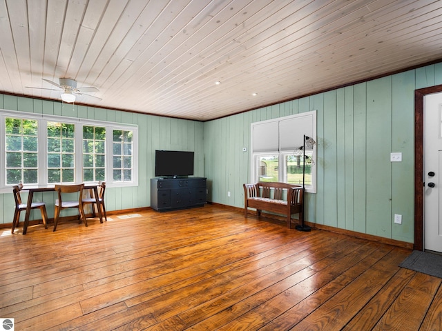 10090 E 48th Rd, Cadillac, MI 49601 - living room with wood-type flooring, wood ceiling, ceiling fan, healthy amount of natural light, and wooden walls