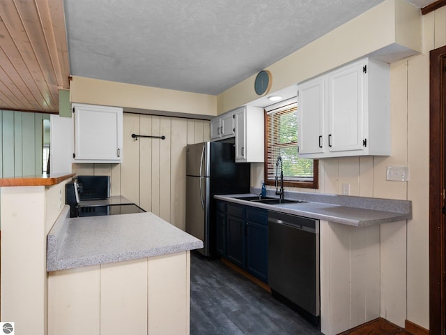 10090 E 48th Rd, Cadillac, MI 49601 - kitchen featuring appliances with stainless steel finishes, white cabinets, dark wood-style floors, and light countertops