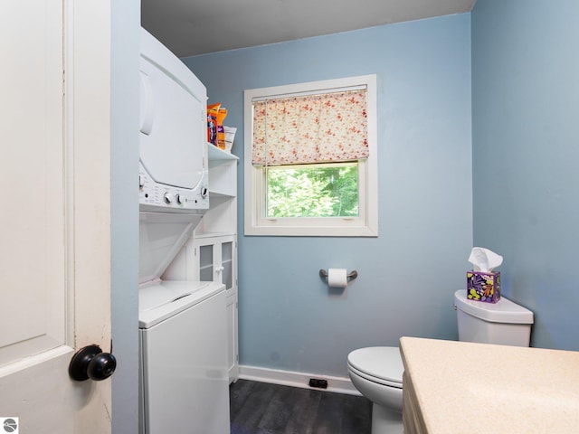 10090 E 48th Rd, Cadillac, MI 49601 - bathroom featuring stacked washing machine and dryer, wood finished floors, and vanity