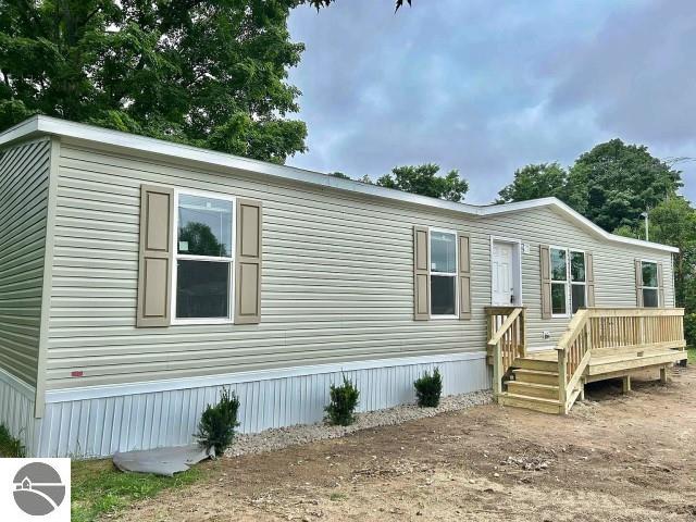 11399 Union St, Fife Lake, MI 49633 - manufactured / mobile home featuring a deck
