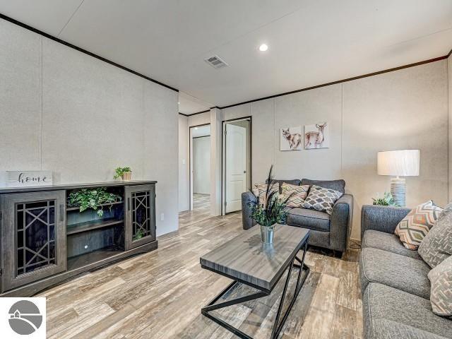 11399 Union St, Fife Lake, MI 49633 - living room featuring wood finished floors and recessed lighting