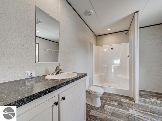 11399 Union St, Fife Lake, MI 49633 - full bath featuring wood finished floors and vanity
