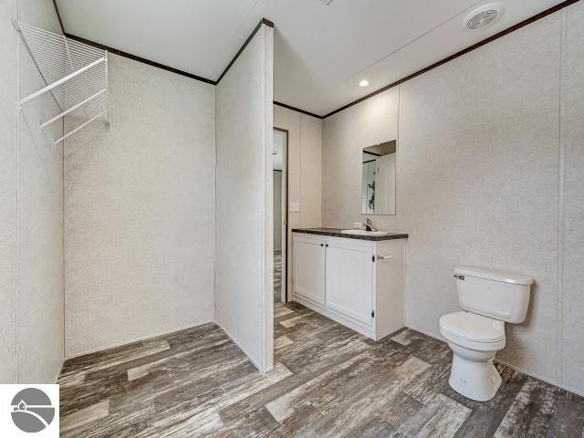 11399 Union St, Fife Lake, MI 49633 - bathroom with wood finished floors and vanity