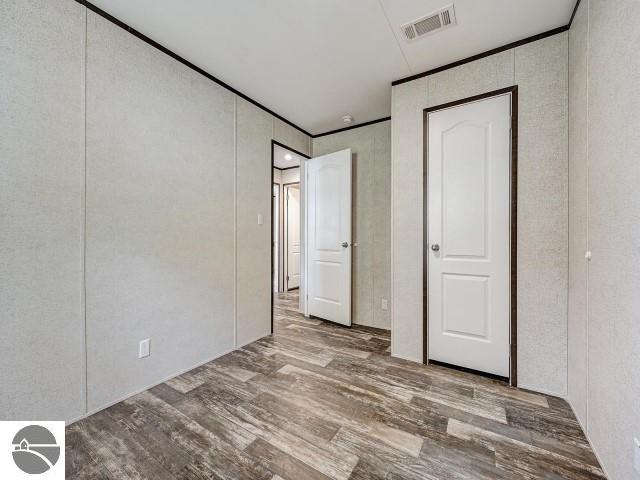 11399 Union St, Fife Lake, MI 49633 - unfurnished bedroom featuring wood finished floors