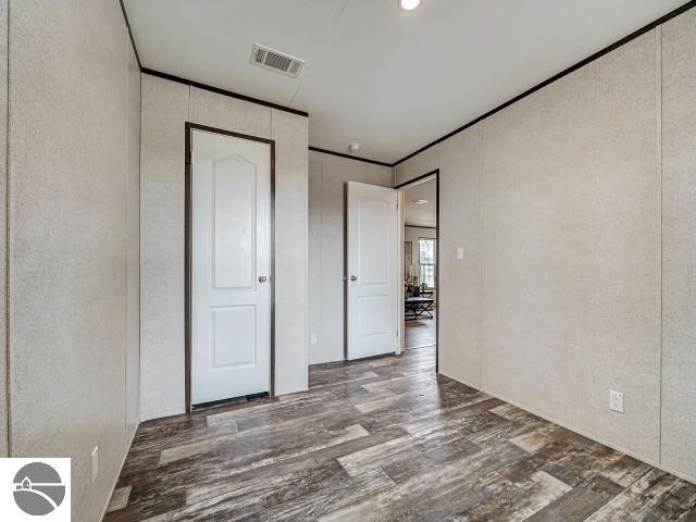11399 Union St, Fife Lake, MI 49633 - unfurnished bedroom with wood finished floors