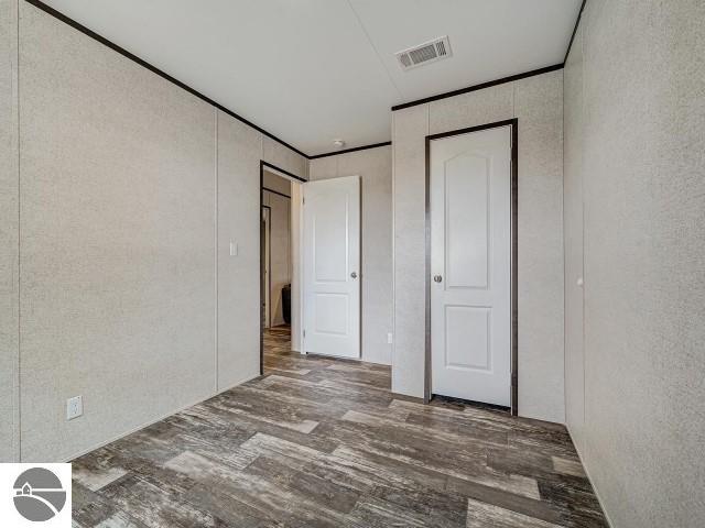 11399 Union St, Fife Lake, MI 49633 - unfurnished bedroom with wood finished floors