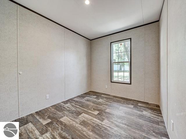11399 Union St, Fife Lake, MI 49633 - unfurnished room with wood finished floors