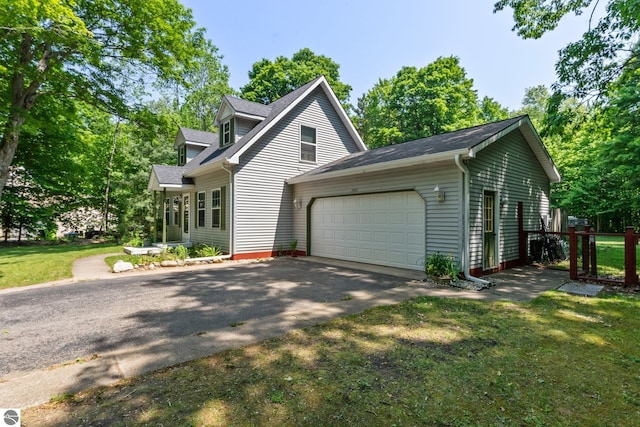 2491 Holland Cir, Traverse City, MI 49685 - view of front facade with a garage, driveway, and a shingled roof