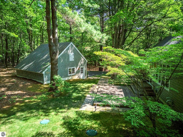 4079 E Oxford Dr, Leland, MI 49654 - view of side of property with a lawn and a wooded view