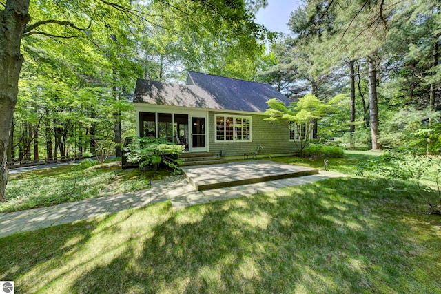 4079 E Oxford Dr, Leland, MI 49654 - rear view of property featuring a patio and a yard